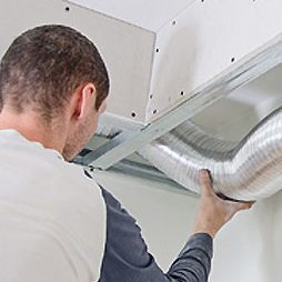 man installing air conditioning ducts